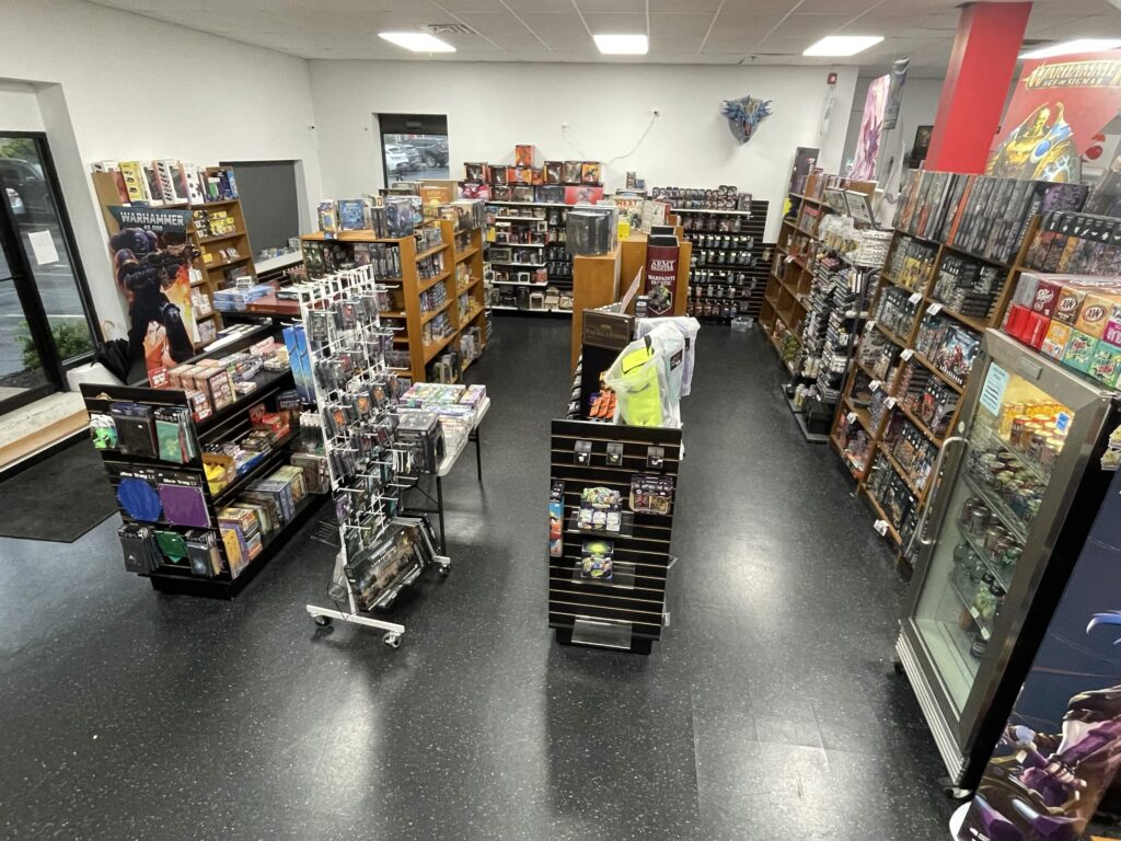 A game store interior with rows of shelves filled with board games