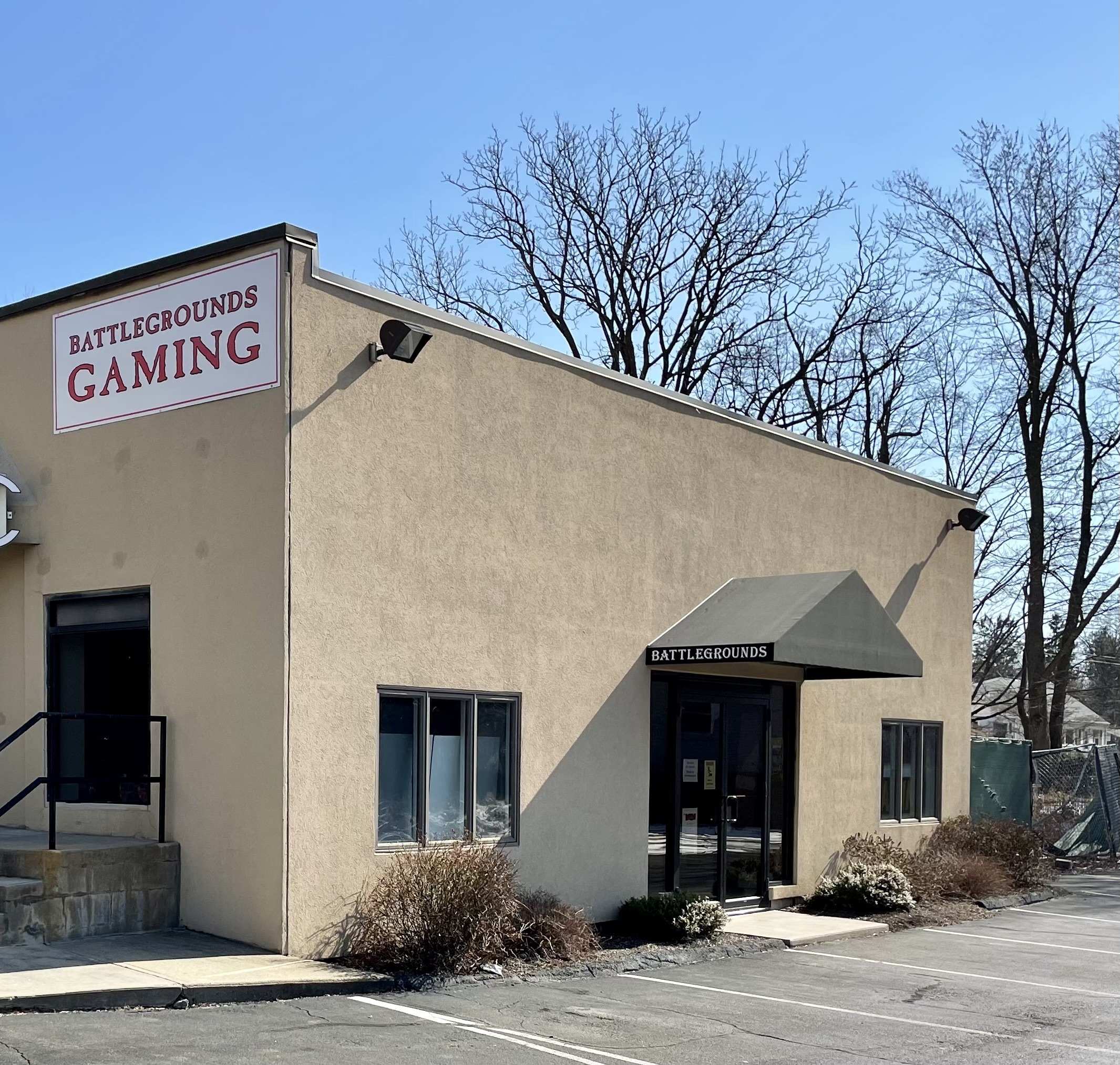 Battlegrounds Gaming storefront features a clear sign against a beige exterior