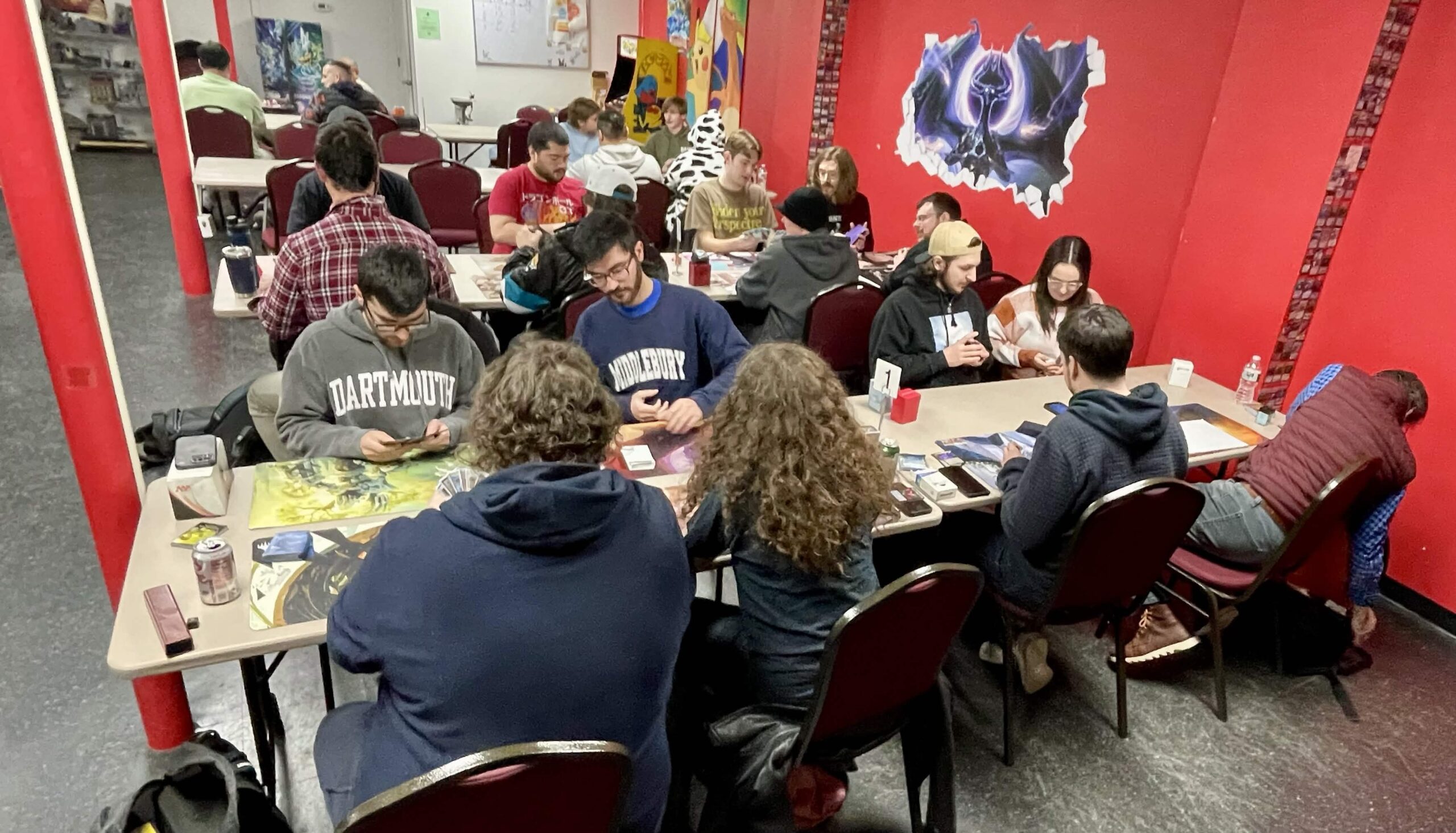 A vibrant game night gathering with diverse participants engaged in card games at tables